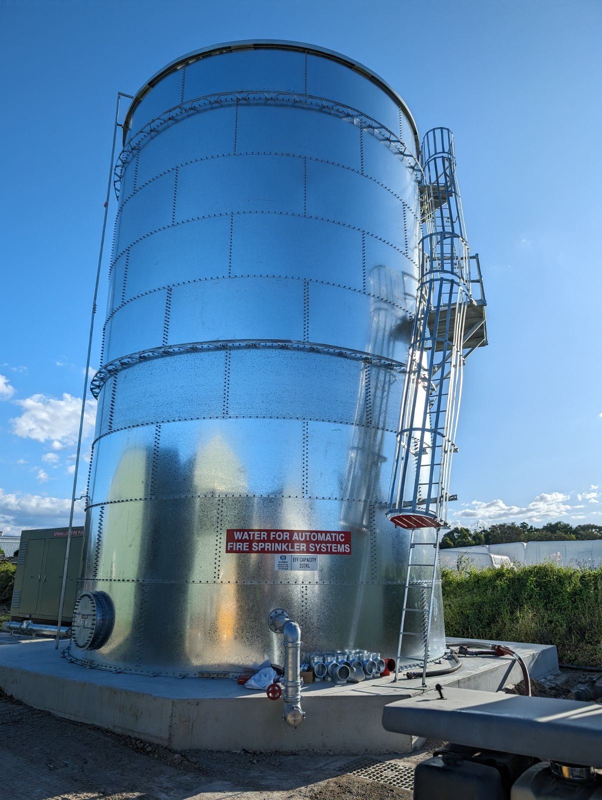 Close-up of a galvanised steel fire sprinkler water tank being filled